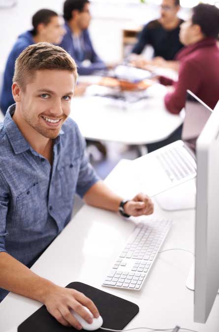 Developer using computer and working at office desk