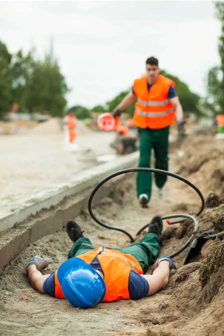 construction worker seriously injured on side of road.